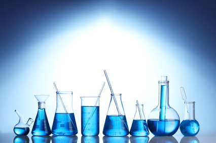 Test-tubes with blue liquid on blue background