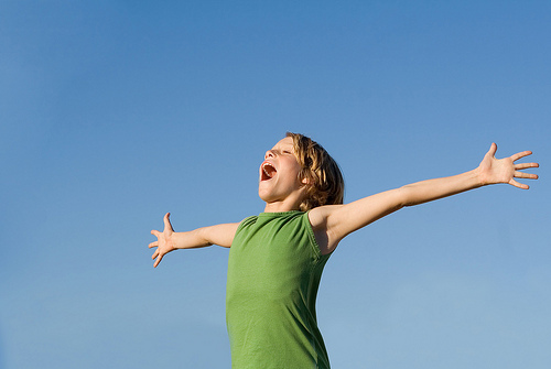 happy child shouting or singing with joy