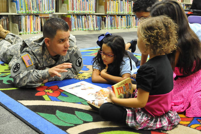 Army 2nd Lt. Monserrate Vergara from the 1st Mission Support Command, U.S. Army Reserve Puerto Rico, reads a Thanksgiving book to children during a story time event. Tell stories as part of your nonprofit's outreach.